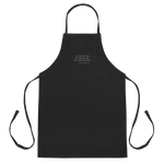 Black apron with embroidered words 'AS FOR ME AND MY HOUSE, WE WILL SERVE BRISKET'.