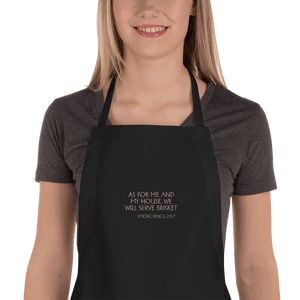 Black apron with embroidered words 'AS FOR ME AND MY HOUSE, WE WILL SERVE BRISKET'.